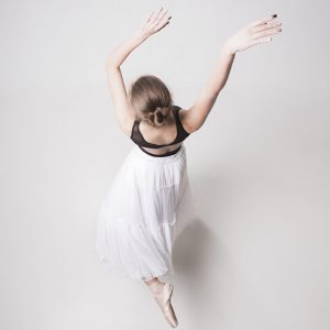 The top view of the teen ballerina on white background